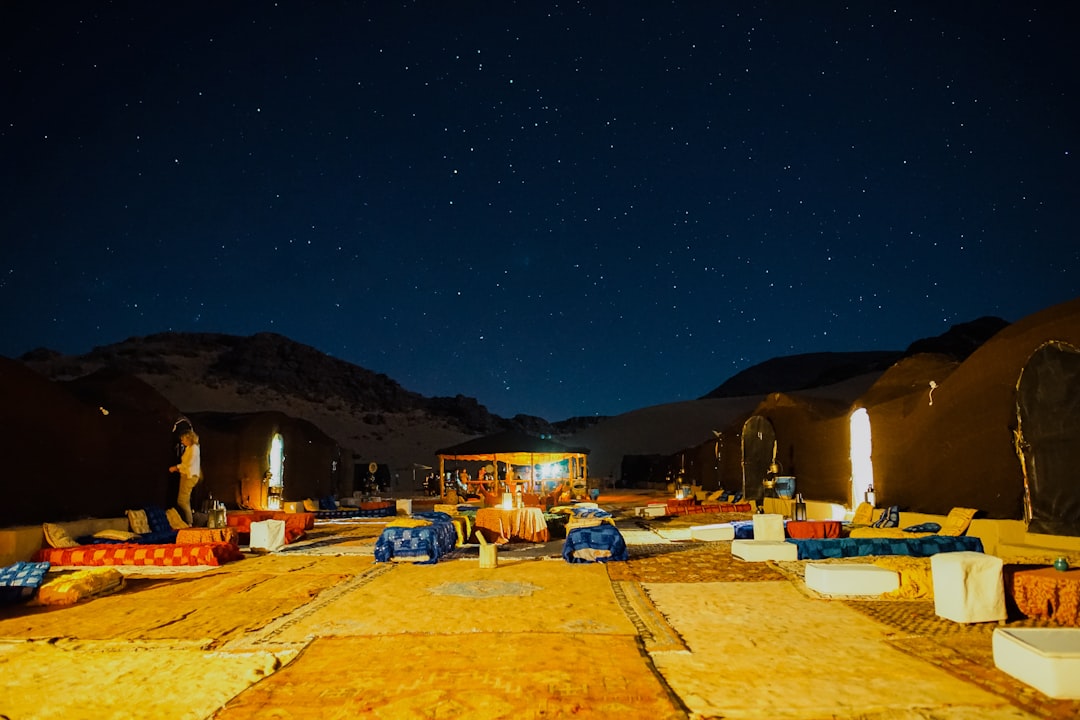4x4 vehicles parked on a dune ridge in Oman